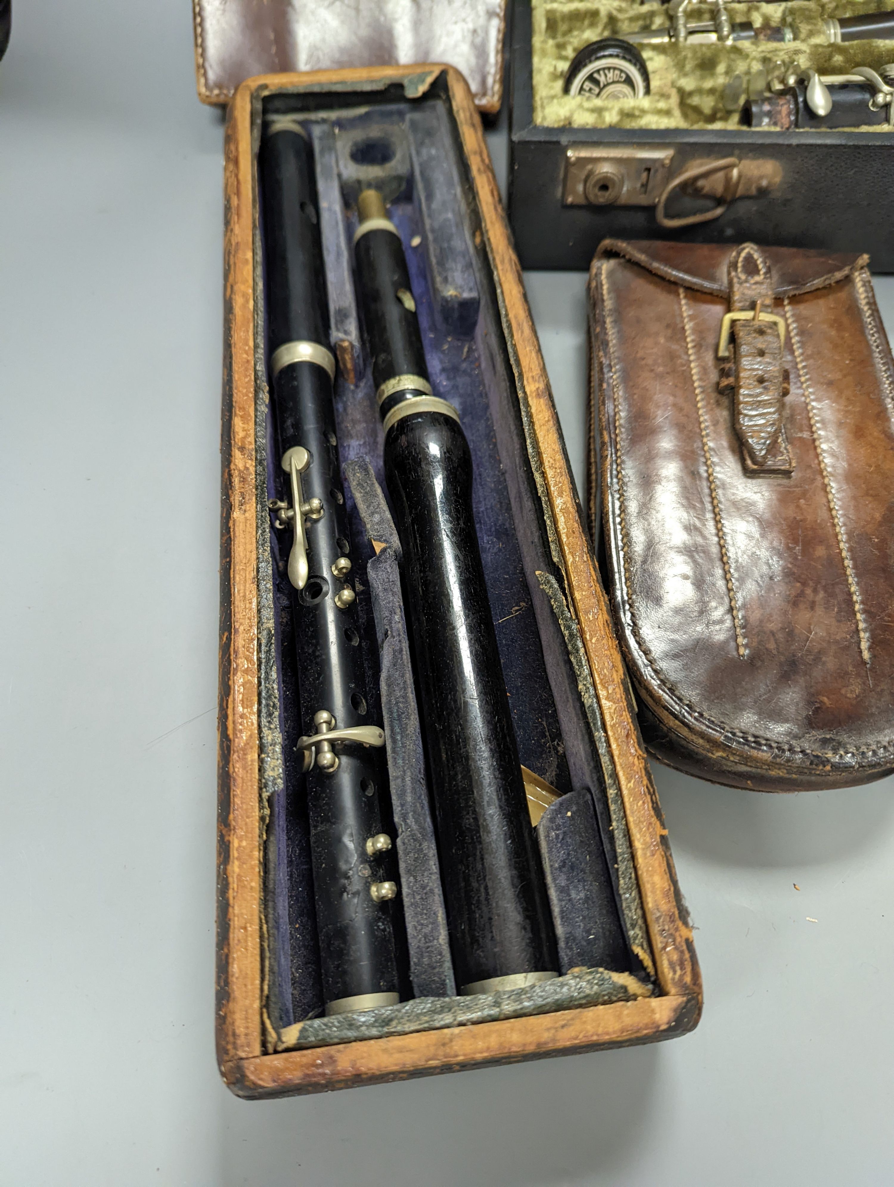 Three ebony or rosewood flutes and a clarinet